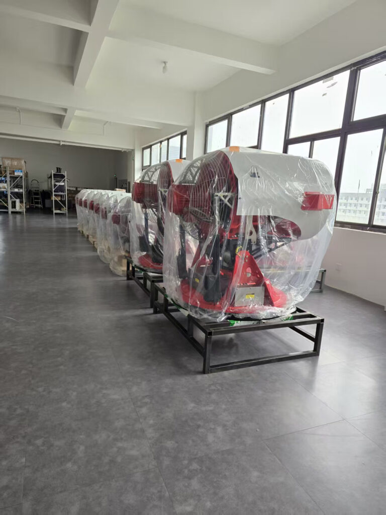 Water mist turbines covered with protective wrapping and arranged on support frames beside workshop windows
