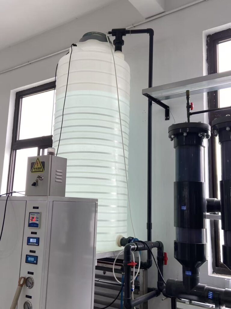 Water storage tank, treatment vessels and control instruments in an ultrapure water supply setup.